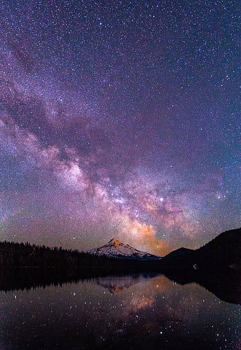 Capture of a brilliant starry night over a serene lake with a mountain peak reflection, creating a magical scene. HD phone wallpaper