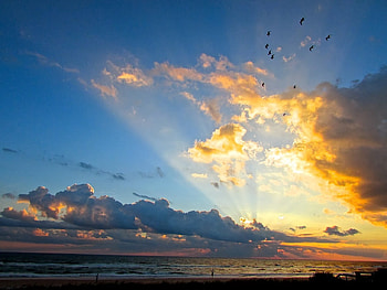 Beautiful sky, blue, sunshine, rays, birds, weather, orange, waves, sunrays, clouds, nature, sky, mountains, ocean HD wallpaper