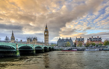 View of Big Ben and Westminster Bridge with dramatic clouds over the River Thames, London. HD wallpaper