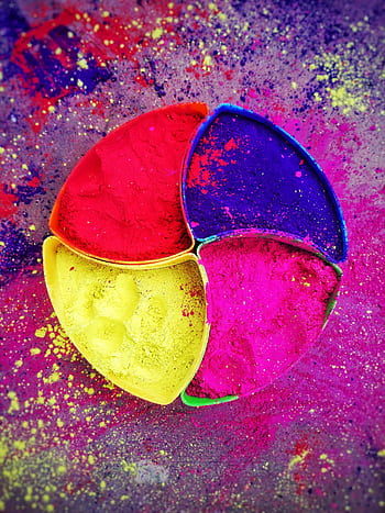 Vibrant Holi powder in colorful segmented dishes, perfect for festival and decoration themes. HD phone wallpaper
