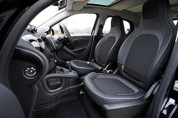 Explore the sleek interior of a modern luxury car featuring leather seats and advanced technology. HD wallpaper