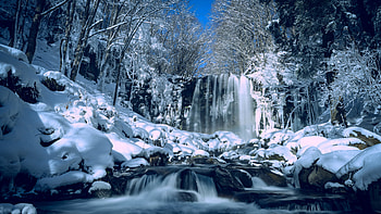 Beautiful Frozen Snow Covered Waterfall Stream Stones Trees Forest In Blue Sky Background During Daytime Winter HD wallpaper