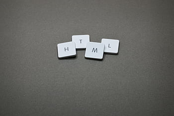 Minimalist of HTML keycaps against a gray background, perfect for digital and web design themes. HD wallpaper