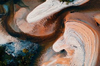 Aerial view showcasing abstract sand patterns and textures in earthy tones. HD wallpaper