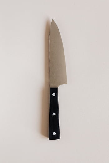 A modern kitchen knife with a black handle, perfect for culinary tasks. HD phone wallpaper