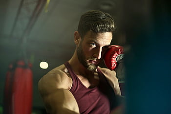 Bearded male boxer in gym focusing intensely during training session. HD wallpaper