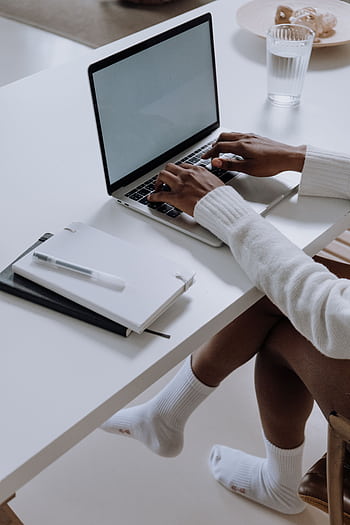 A woman working on a laptop in a modern home office setting, capturing a cozy and productive atmosphere. HD phone wallpaper
