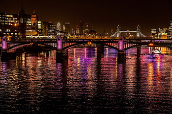 City, night at bridge, colorful glow on water HD wallpaper
