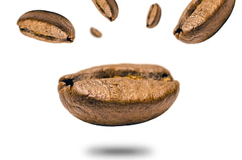 Close-up of levitating coffee beans against a white backdrop, highlighting texture. HD wallpaper