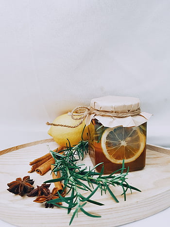 Artistic arrangement of lemon, herbs, and honey jar for DIY herbal tea. HD phone wallpaper