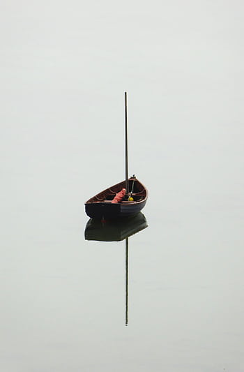 Solitary boat floats on calm water with a perfect reflection, creating a serene and tranquil scene. HD phone wallpaper