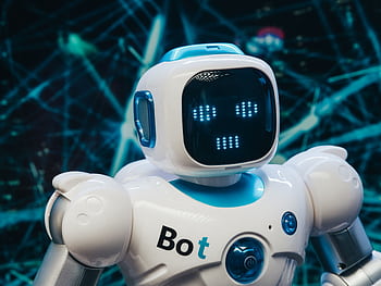 Close-up of a futuristic humanoid robot with a digital face display, representing modern technology. HD wallpaper