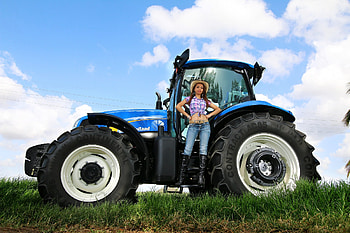 Cowgirl on her New Holland Tractor, tractor, cowgirl, boots, jeans, brunette HD wallpaper