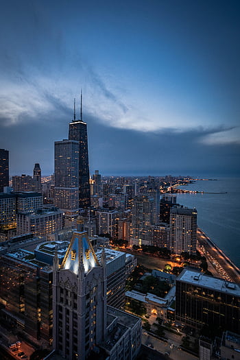 A breathtaking aerial view of Chicago's skyline featuring the iconic John Hancock Center at twilight. HD phone wallpaper