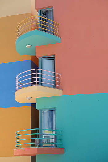 Bright colorful building with modern balconies in Portugal's vibrant architecture. HD phone wallpaper