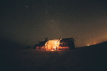 A serene night in Egypt's desert, capturing a starry sky and a warmly lit tent under the Milky Way. HD wallpaper