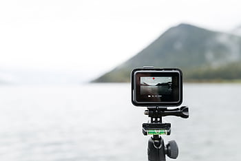 A close-up of an action camera filming a serene lake in Bay of Plenty. HD wallpaper