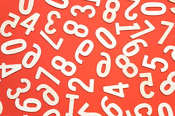 Artistic scattered white numbers on a bright red background, geometric and abstract. HD wallpaper
