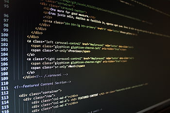 Close-up of HTML code displayed on a computer monitor, showcasing web development. HD wallpaper