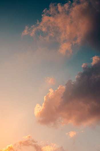 Captivating sky with dramatic clouds illuminated during sunset, creating a peaceful and scenic atmosphere. HD phone wallpaper