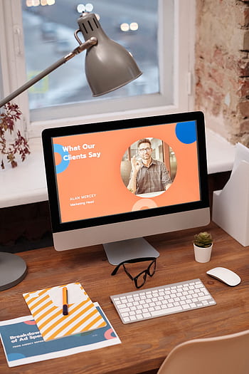 Stylish home office setup with computer showcasing client testimonials. HD phone wallpaper