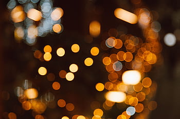 A mesmerizing display of golden bokeh lights, evoking warmth and celebration. HD wallpaper