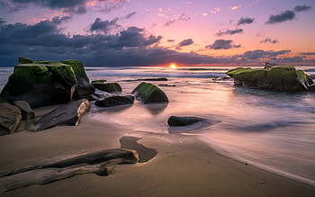 Sunrise over Beach, water, coast, beach, sunrise, rocks HD wallpaper