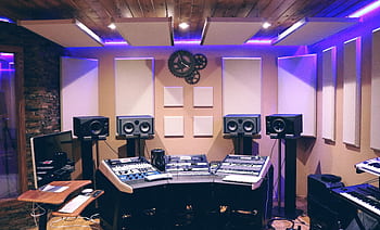 Modern recording studio with high-tech audio equipment and stylish lighting. HD wallpaper