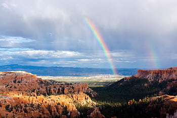 Spectacular double rainbow arches over Bryce Canyon's unique geological formations. HD wallpaper