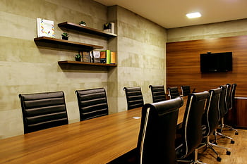 Elegant boardroom with leather chairs and wooden decor, ideal for meetings. HD wallpaper
