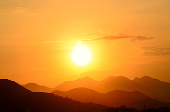 Stunning sunset over Rio de Janeiro's mountains, capturing the vibrant golden hues and silhouettes. HD wallpaper