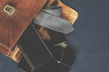Flat lay of men's leather bag with accessories like a tie, notebook, and . Ideal for business themes. HD wallpaper