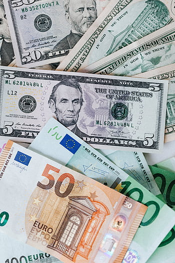 A collection of US dollars and Euro banknotes symbolizing wealth, finance, and global economy. HD phone wallpaper