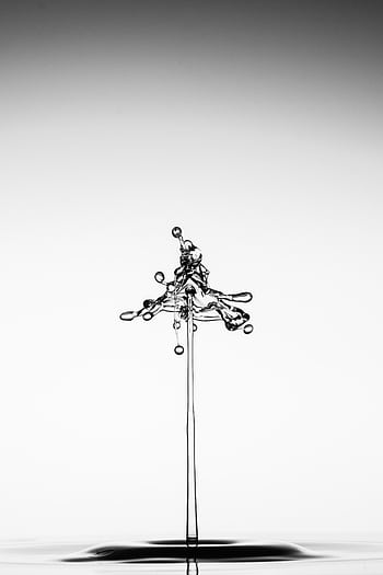 Artistic capture of a water splash creating a unique shape against a minimalist background. HD phone wallpaper