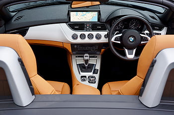 Explore the modern interior of a BMW convertible with leather seats and advanced features. HD wallpaper