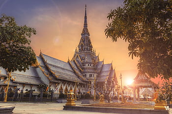 Scenic view of Wat Sothonwararam Temple during sunset in Thailand, capturing its beautiful architecture. HD wallpaper