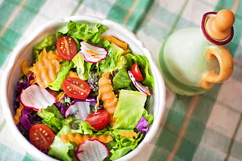 Colorful fresh vegetable salad with cherry tomatoes in a white bowl. HD wallpaper