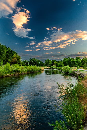 Peaceful river landscape with lush greenery and a vibrant sunset sky in Taylorsville, Utah. HD phone wallpaper
