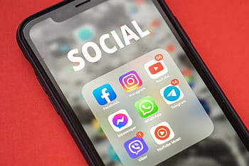 Close-up of a smart showing popular social media apps on screen. HD wallpaper