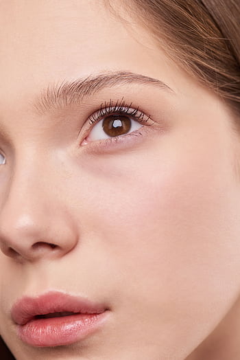 Close-up portrait capturing the natural beauty and smooth skin of a young woman. HD phone wallpaper