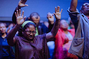 People gathered in a heartfelt prayer meeting, expressing unity and devotion. HD wallpaper