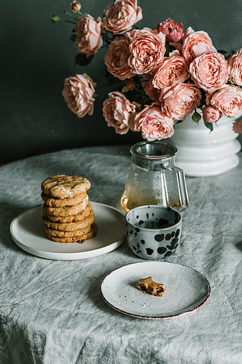 Enjoy rustic elegance with homemade cookies and tea beside vintage floral decor. HD phone wallpaper