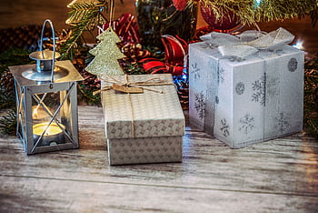Festive Christmas scene with wrapped gifts, lantern, and holiday decorations. HD wallpaper
