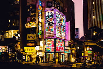 Explore the vibrant nightlife of Shinjuku, Tokyo with colorful neon signs illuminating the bustling streets. HD wallpaper