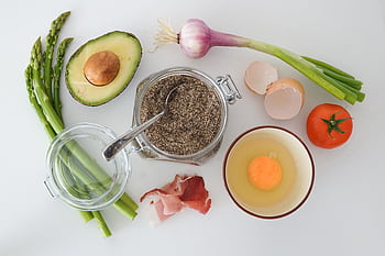 Flat lay of fresh asparagus, avocado, egg, tomato, and more for a keto-friendly dish. HD wallpaper