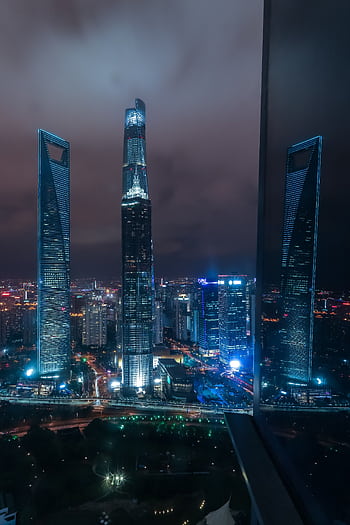 Breathtaking view of Shanghai's illuminated skyscrapers at night, showcasing modern architecture. HD phone wallpaper