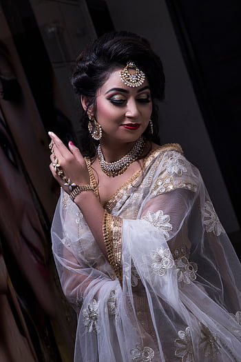 A stunning bride in a traditional wedding outfit with a sheer veil and intricate jewelry. HD phone wallpaper