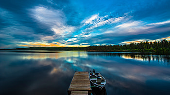 Boat Near Wood Dock On Lake Green Trees Under White Clouds Blue Sky Reflection On Water Nature HD wallpaper