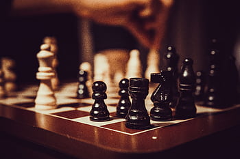 Close-up of a chessboard showcasing strategy, tactics, and focus in a competitive game. HD wallpaper