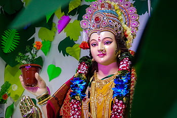 Vibrant Durga idol adorned for festival in Mumbai, showcasing Hindu cultural traditions. HD wallpaper